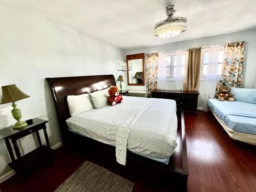 a bedroom with a bed with a teddy bear on it at Group Getaway of West New York in West New York
