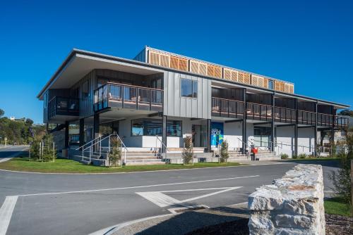 a large building with a road in front of it at Kaiteriteri Reserve Apartments in Kaiteriteri