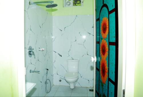 a bathroom with a toilet and a shower at Greeny Homestay in Cochin