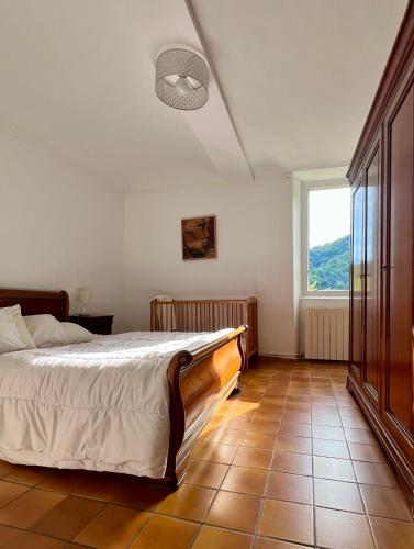 a bedroom with a bed and a large window at Gîte en Cévennes in Sumène