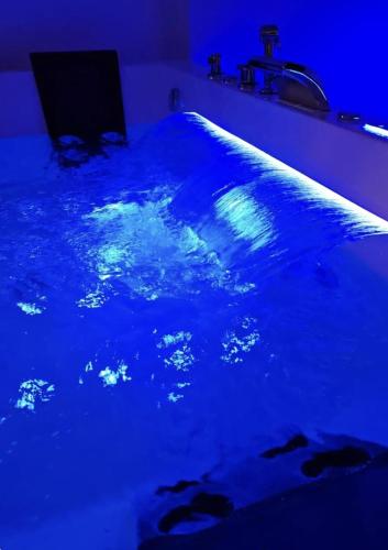 a swimming pool with blue lights in a room at Villa Primodì in Bologna