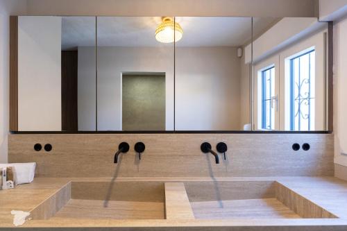 a bathroom with a sink with a large mirror at Casa SD in Casas de Torrat
