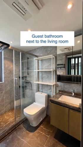 a bathroom with a toilet and a sink at Family-friendly apartment in Dongguan