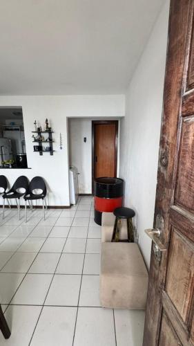 a living room with a table and chairs and a room at Casa Mirante da Sereia in Salvador