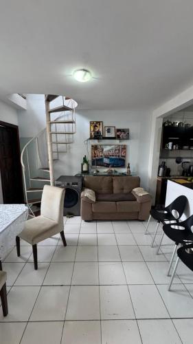 a living room with a couch and chairs at Casa Mirante da Sereia in Salvador