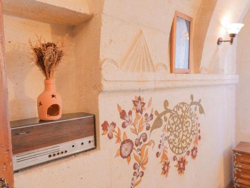 a wall with a flower mural on a wall at Kismet Cave House in Göreme