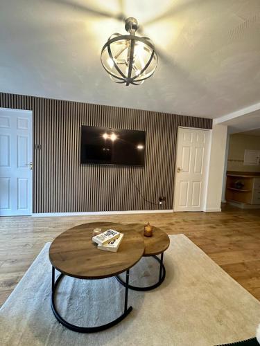 a living room with a table and a tv at Spacious apartment in Leigh woods in Bristol