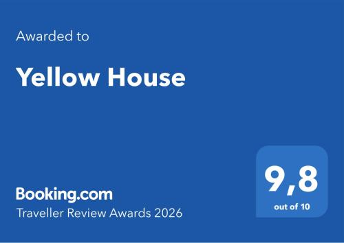 a yellow house with a blue background with the text awarded to yellow house at Yellow House in Tavira