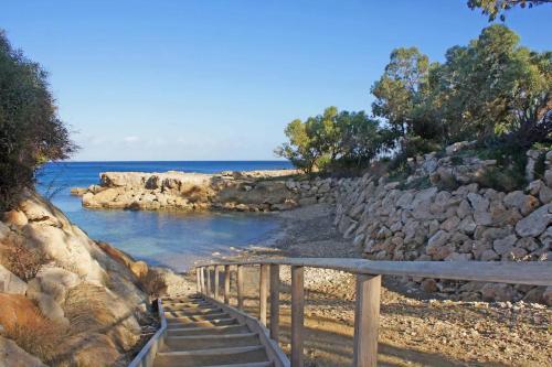 a set of stairs leading to a beach with the ocean at Milepost vacations in Paralimni