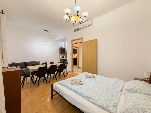 a bedroom with a bed and a table and chairs at K13 Gozsdu Apartment in Budapest