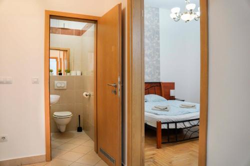 a room with a bed and a bathroom with a toilet at K13 Gozsdu Apartment in Budapest