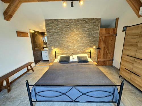a bedroom with a large bed and a brick wall at Casa Cingoli in Cingoli