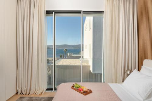 a bedroom with a bed with a tray of fruit on it at Villa Valea - Managed by Excelsior Villas in Turanj