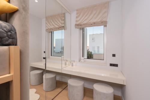 a bathroom with a window with stools in front of it at Villa Valea - Managed by Excelsior Villas in Turanj