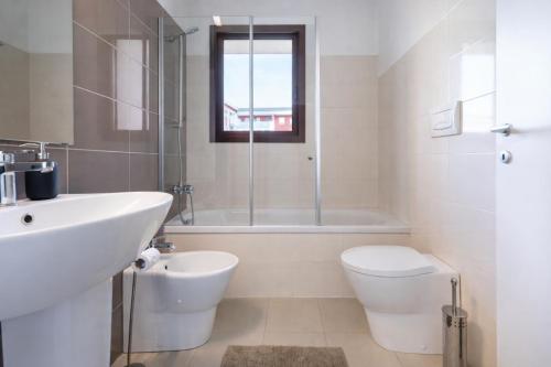 a bathroom with a sink and a toilet and a shower at Sarca 11th Floor in Milan