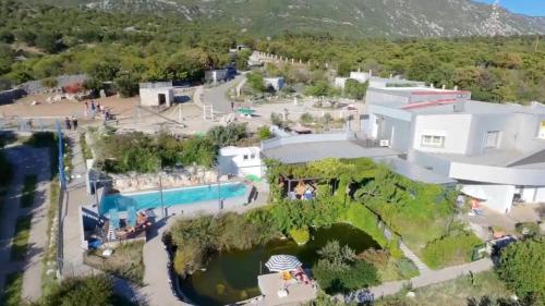 an aerial view of a house with a pool at Villa Suzi - Family Farm Stay with Donkeys, Pool and Sea View near Rijeka in Šmrika