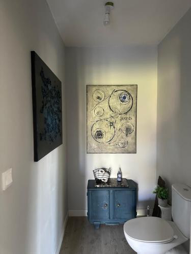 a bathroom with a blue cabinet and a toilet at L Ecrin d Anabelle in Saint-Georges-lès-Baillargeaux