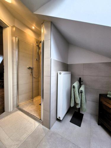 a bathroom with a shower and a walk in shower at # Ausblick LübEck in Lübeck