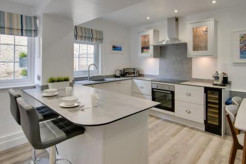 a kitchen with white cabinets and a large island at 2 Bed in Kingsbridge oc-bc3188 in Kingsbridge