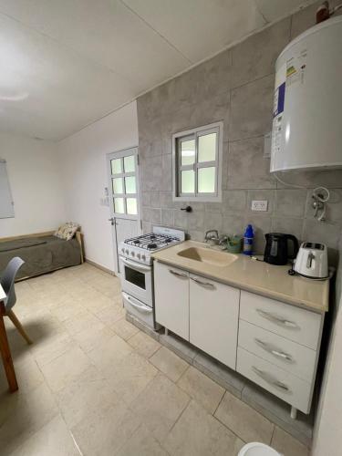 a kitchen with a sink and a stove top oven at Cabaña 36 termas in Chajarí