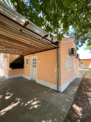 a garage with awning in front of a house at Cabaña 36 termas in Chajarí