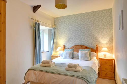 a bedroom with a bed with two towels on it at 2 Bed in Carmel oc-wai211 in Llanerchymedd