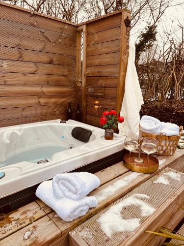 a bath tub with towels on a wooden deck at Hyggeligt hus i Haderslev med wellness og massage in Haderslev