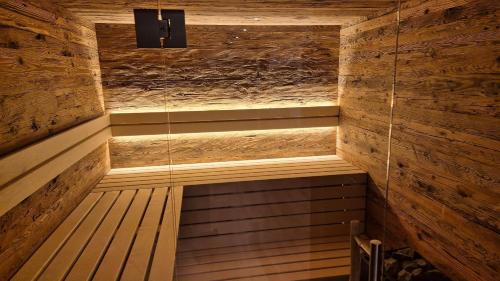 an empty sauna with wooden walls and wooden floors at Chalet Auszeit - Wohlfühlzeit Naturdesign Chalet`s in Rimbach