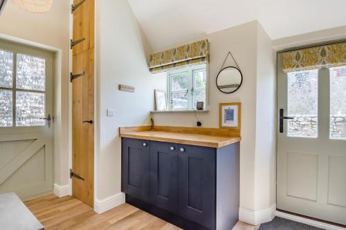a kitchen with a blue cabinet and a door at 3 Bed in Cley oc-t32433 in Cley next the Sea