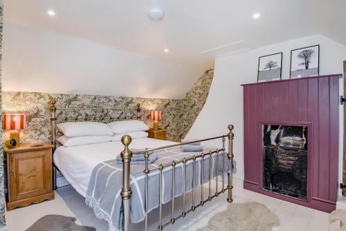 a bedroom with a bed and a fireplace at 3 Bed in Cley oc-t32433 in Cley next the Sea