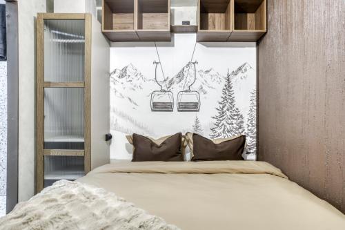 Appartement F&F في كوردون: غرفة نوم بها سرير ومصعدان للتزلج