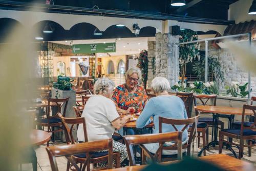 two older women sitting at a table in a restaurant at 't Hooge Holt in Gramsbergen