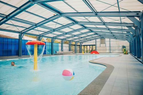 a person in a pool with a ball in the water at 't Hooge Holt in Gramsbergen