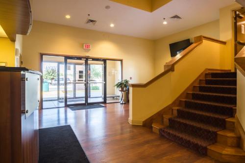a lobby with a staircase and a door to a building at Motel 6-Indianapolis, IN - Airport in Indianapolis