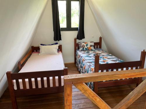 a bedroom with two beds and a window at Le ZANATANY BEACH in Tamatave
