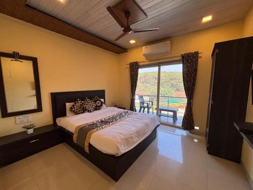 a bedroom with a bed and a window with a balcony at Aroma Residency 2bhk villa & delux rooms in Mahabaleshwar