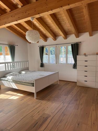 a bedroom with a bed in a room with wooden ceilings at Chalet Gadmer Herz in Gadmen