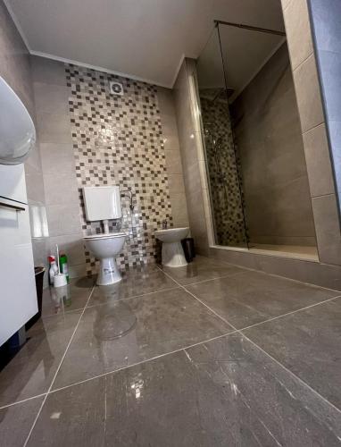 a large bathroom with a toilet and a shower at Beautiful duplex apartment with view in Kaštela