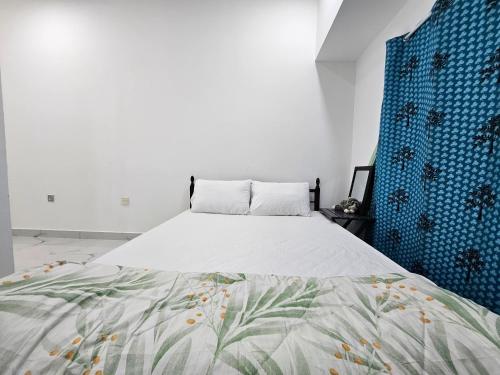 a bedroom with a large bed with blue walls at Everest Stay in Abu Dhabi