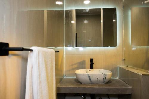 a bathroom with a sink and a mirror at Zango Apartments in Shikalenge