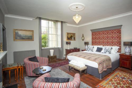 a bedroom with a large bed and two chairs at 2 Bed in Bath oc-bhr35 in Bath