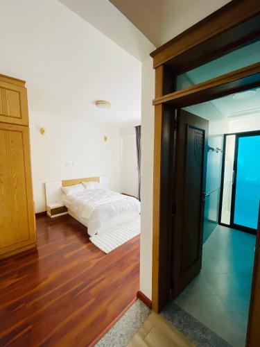 a bedroom with a bed and a sliding glass door at Abat property Rental in Addis Ababa