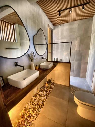 a bathroom with a sink and a mirror at MAPUWI Villa & Suite in Palomino