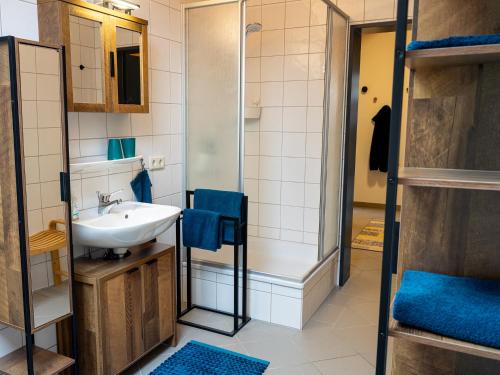 a bathroom with a sink and a shower at Landhaus Kummerfrei in Hellenthal