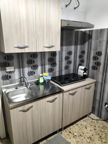 a kitchen with a sink and a stove at Casa Vacanza Casale in Brindisi