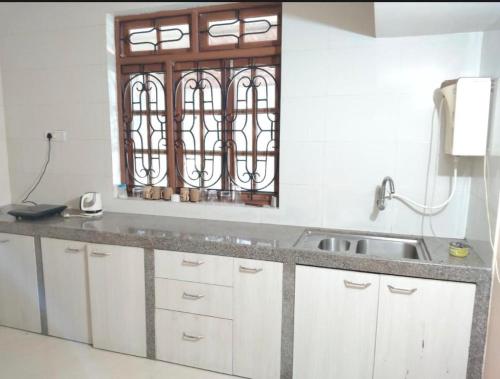 a kitchen with a sink and a window at GA Fernandes house in Colva