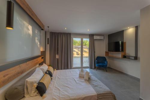 a bedroom with a large bed and a tv at Villa Omega in Lévktron