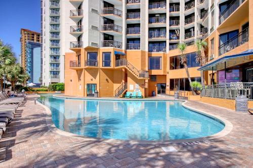 a swimming pool in front of a building at The Patricia Grand in Myrtle Beach