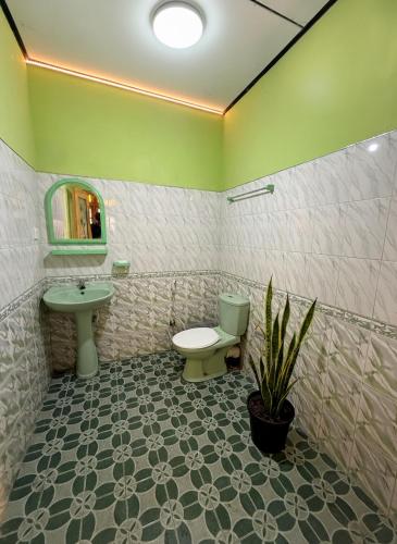 a bathroom with a sink and a toilet and a mirror at The Bunker Hostel Ella in Ella