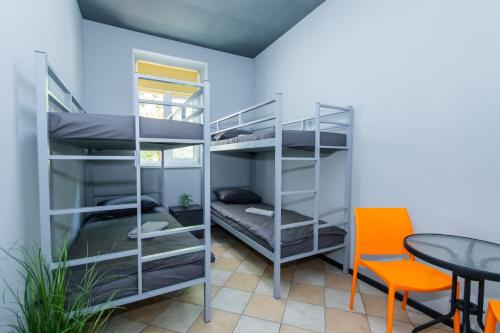 a room with bunk beds and a table and chairs at Seven Apart Hotel in Vyshneve